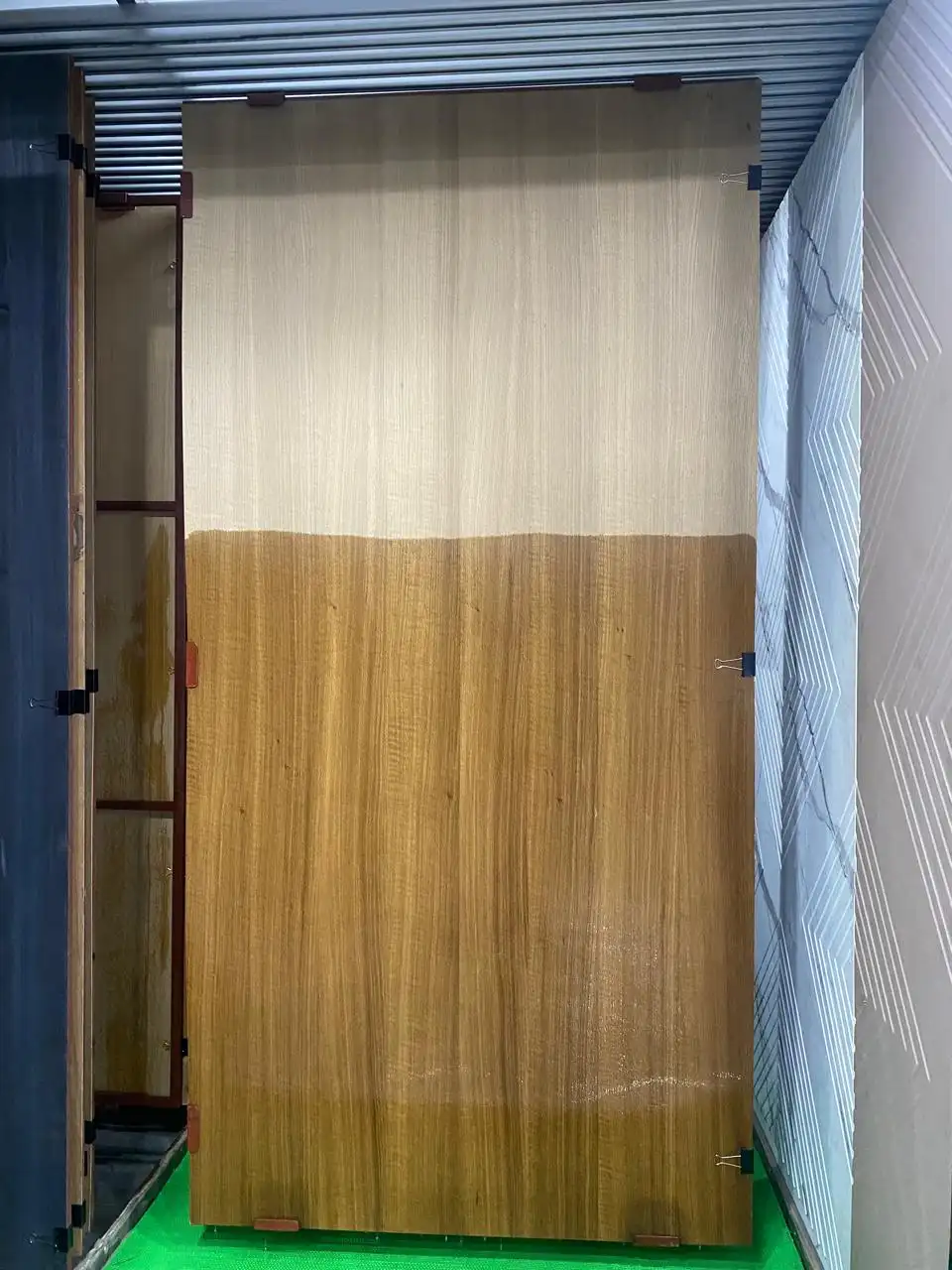 Golden teak-finish door sheet in the showroom display rack