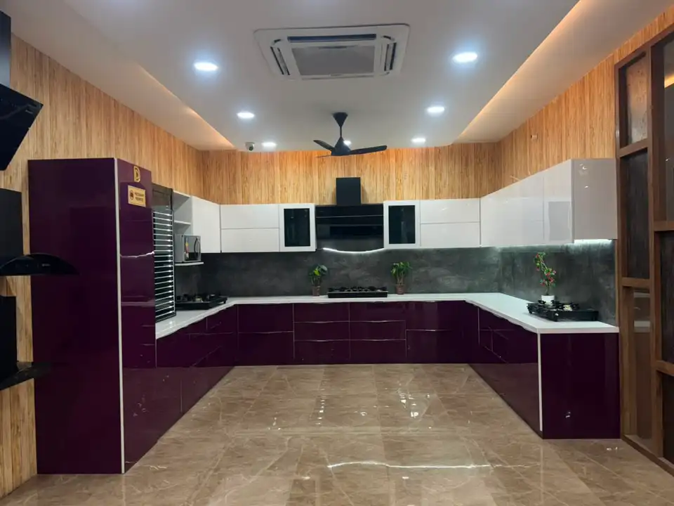 U-shaped modular kitchen display with purple gloss base units and white overhead cabinets