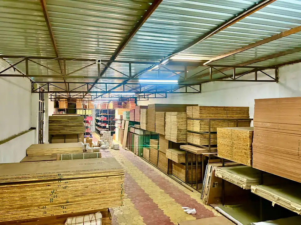 Wide warehouse view of plywood and board inventory on floor-to-ceiling racks