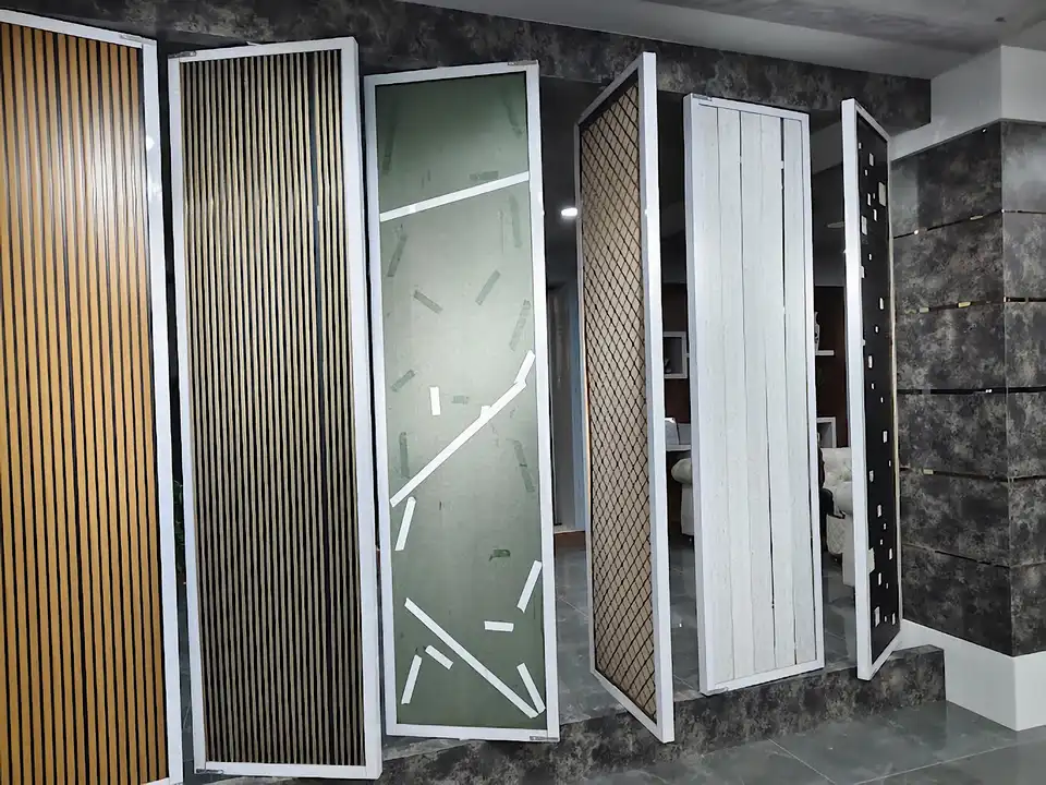 Six decorative wall panel samples displayed on a stone platform in the showroom